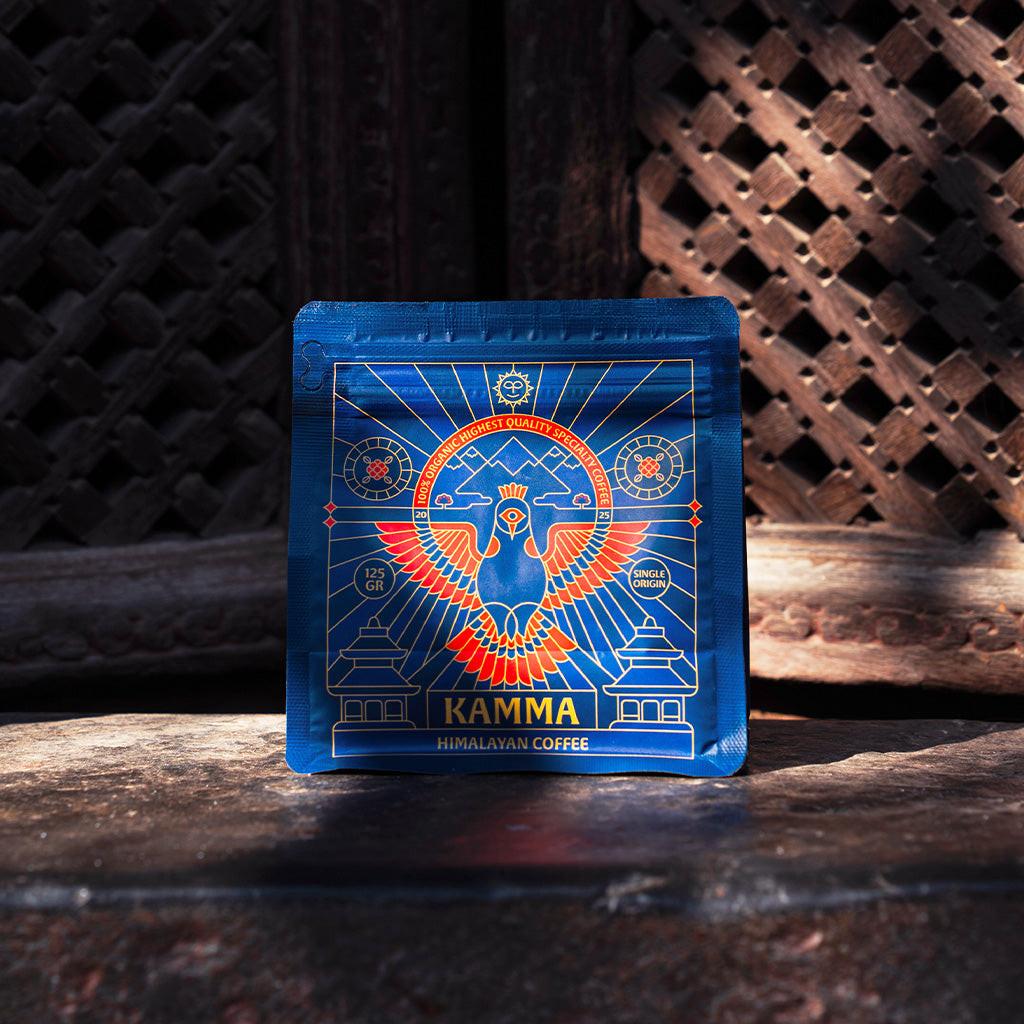 Kamma Himalayan Coffee package on a dark surface with a textured background